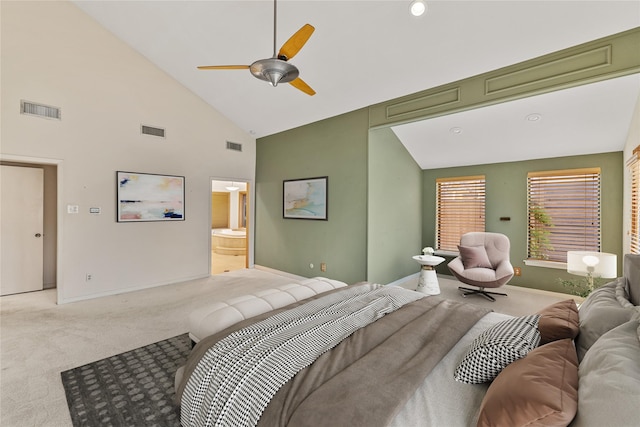 carpeted bedroom featuring ceiling fan, ensuite bathroom, and high vaulted ceiling