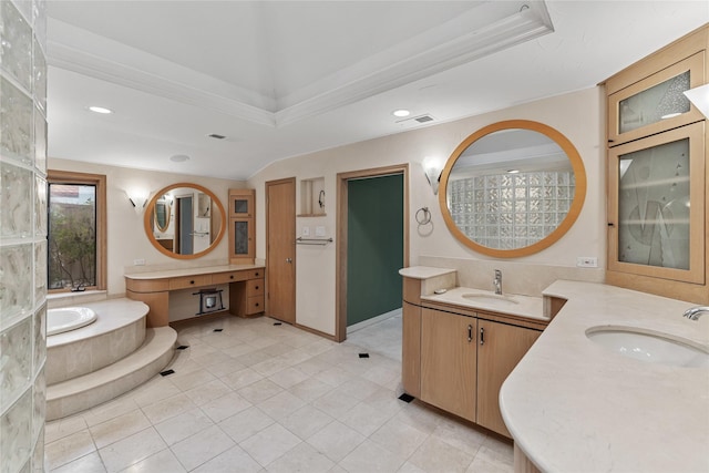 bathroom with lofted ceiling, vanity, a raised ceiling, and tiled tub