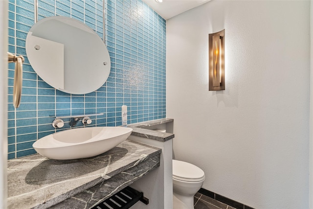 bathroom featuring tile patterned flooring, vanity, and toilet