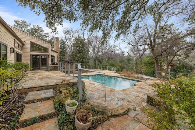 view of swimming pool with a patio area