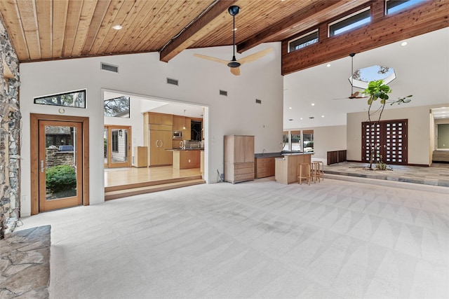 carpeted living room with beam ceiling, high vaulted ceiling, and wood ceiling