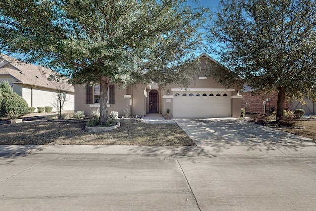 9113 Compton St, Denton, TX 76207 - view of front of property featuring stucco siding, an attached garage, and driveway