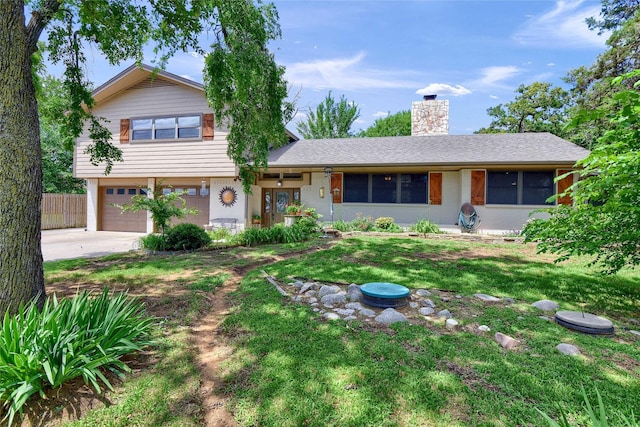 view of front of property with a garage and a front yard