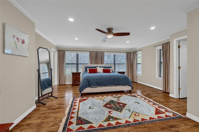 bedroom with dark wood-type flooring, ceiling fan, and ornamental molding