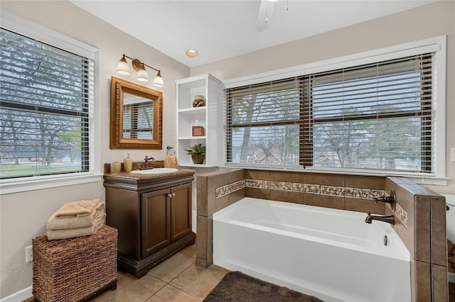 bathroom with vanity, a bathtub, tile patterned floors, and ceiling fan