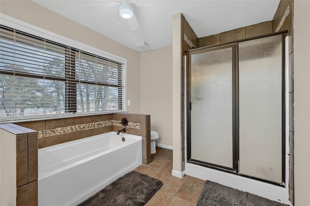 bathroom featuring tile patterned floors, toilet, and separate shower and tub