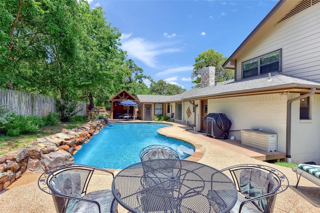 view of swimming pool featuring a patio and area for grilling