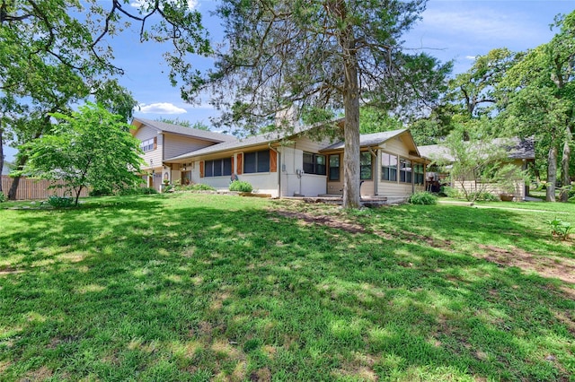 rear view of house with a lawn