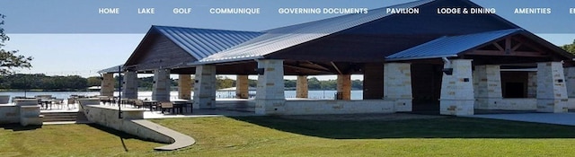 view of community with a gazebo, a water view, a patio area, and a lawn