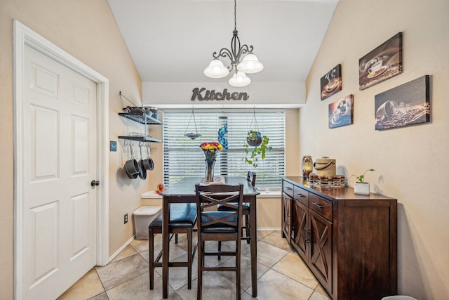 tiled dining area featuring lofted ceiling and a chandelier