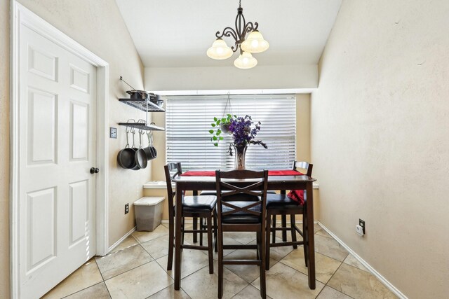 kitchen featuring a breakfast bar area, appliances with stainless steel finishes, light stone countertops, decorative light fixtures, and kitchen peninsula