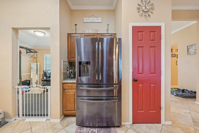 kitchen with stainless steel fridge with ice dispenser, crown molding, and light tile patterned flooring