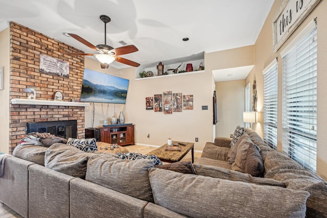 living room featuring ornamental molding, ceiling fan, and a fireplace