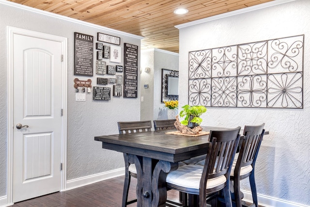 dining space with ornamental molding, dark hardwood / wood-style floors, and wooden ceiling