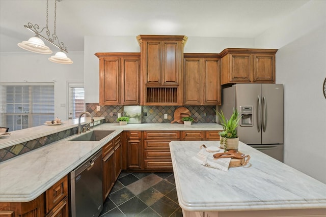 kitchen with sink, decorative light fixtures, stainless steel fridge, dishwasher, and backsplash