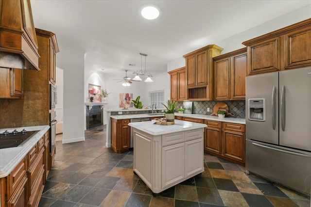 kitchen featuring hanging light fixtures, stainless steel appliances, a center island, decorative backsplash, and kitchen peninsula