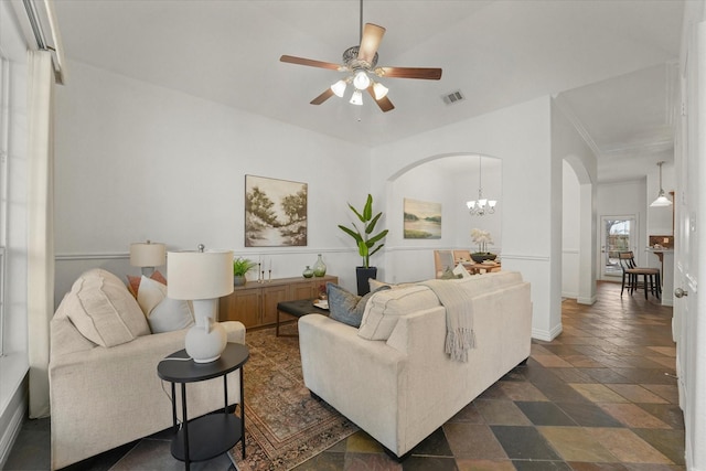 living room featuring ceiling fan with notable chandelier