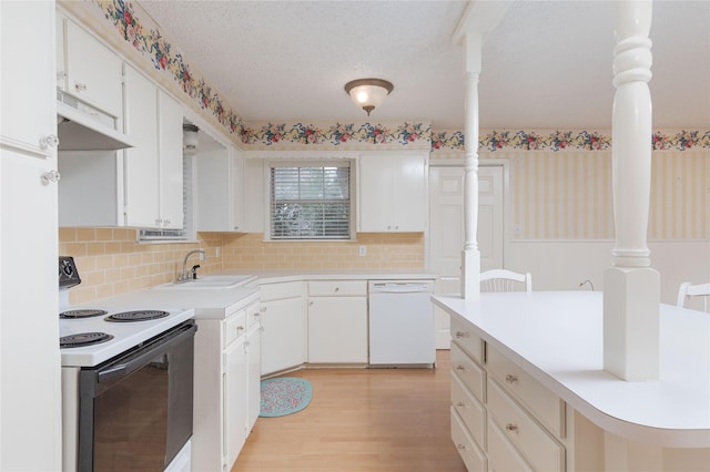 kitchen with sink, white cabinetry, a textured ceiling, white appliances, and light hardwood / wood-style floors