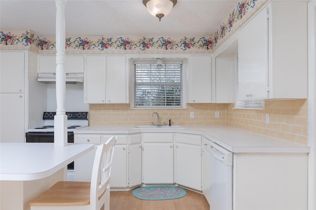 kitchen with tasteful backsplash, white cabinetry, sink, white appliances, and light hardwood / wood-style flooring