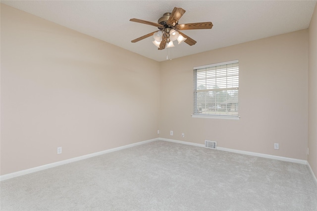 carpeted empty room featuring ceiling fan