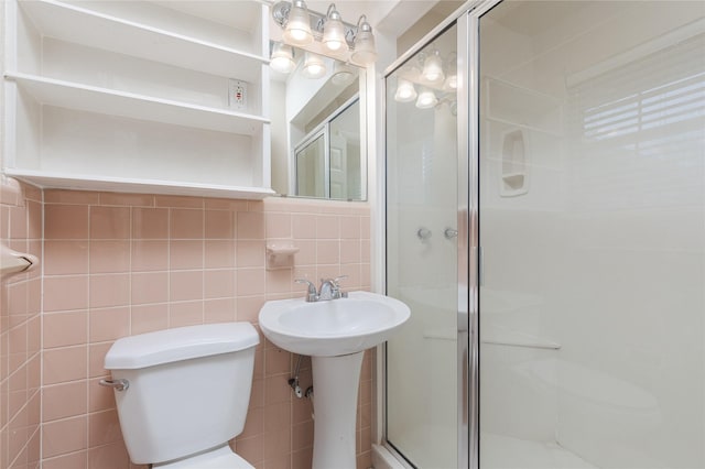 bathroom featuring walk in shower, toilet, and tile walls