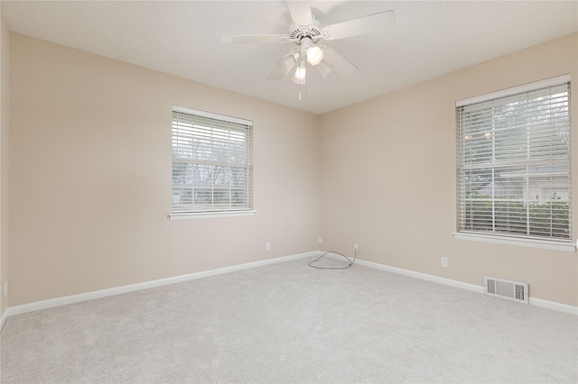 empty room with light carpet and ceiling fan