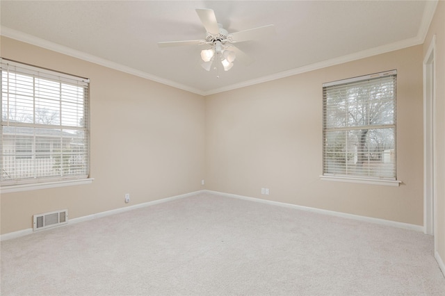 carpeted empty room with crown molding and ceiling fan