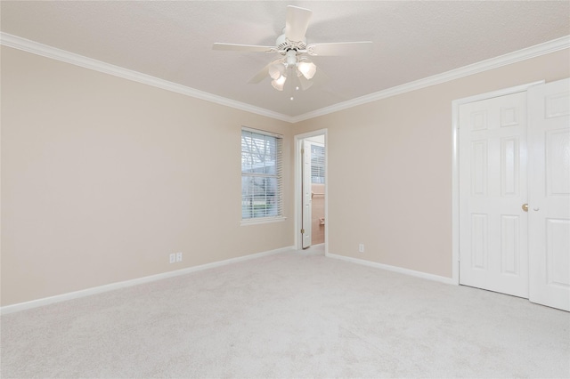 unfurnished bedroom with crown molding, light carpet, a textured ceiling, and ceiling fan