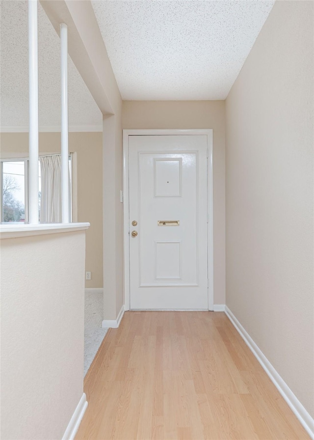 entryway featuring a textured ceiling and light wood-type flooring