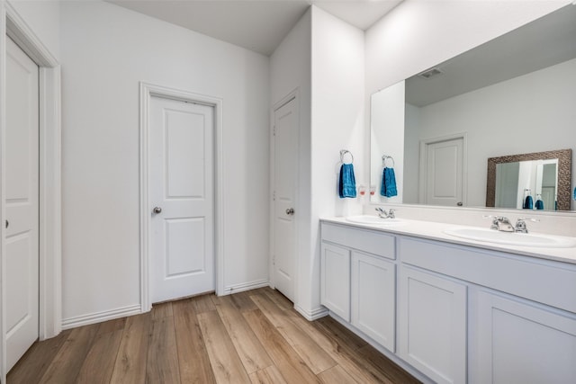 bathroom featuring hardwood / wood-style flooring and vanity