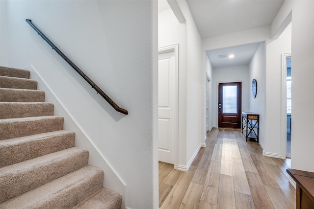 interior space with baseboards and wood finished floors