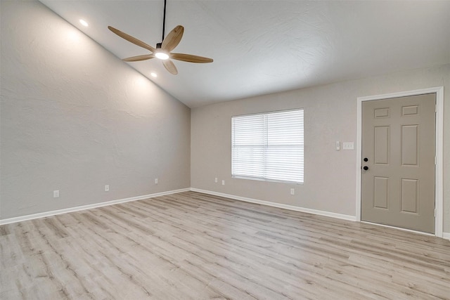 unfurnished room featuring lofted ceiling, ceiling fan, and light wood-type flooring