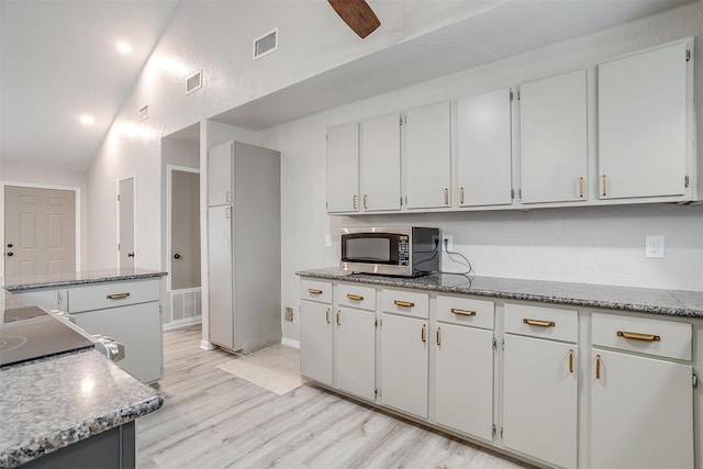 kitchen with white cabinetry and light hardwood / wood-style flooring