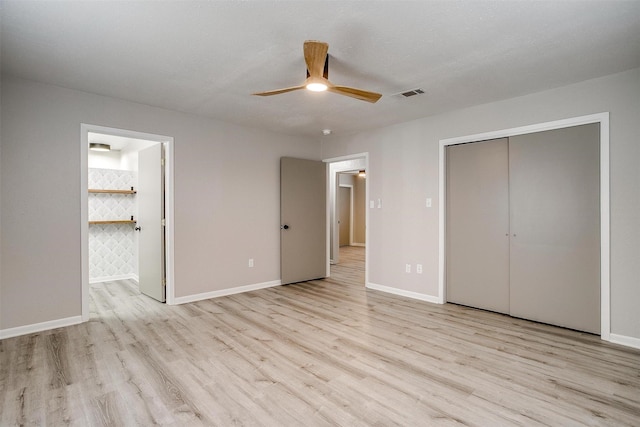 unfurnished bedroom with connected bathroom, light hardwood / wood-style flooring, a closet, and ceiling fan