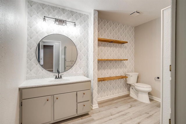 bathroom featuring hardwood / wood-style flooring, vanity, and toilet