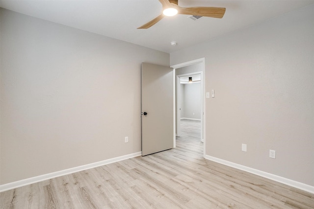 empty room with ceiling fan and light hardwood / wood-style flooring