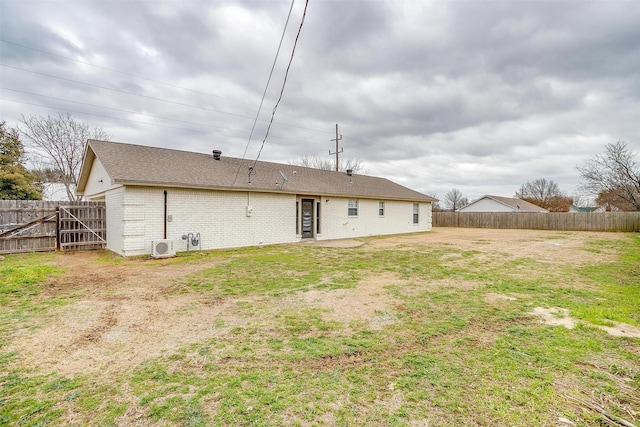 rear view of property featuring a lawn