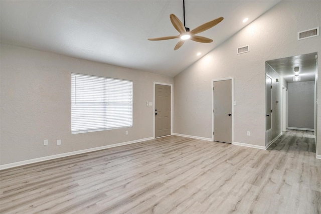 empty room featuring ceiling fan, high vaulted ceiling, and light hardwood / wood-style flooring