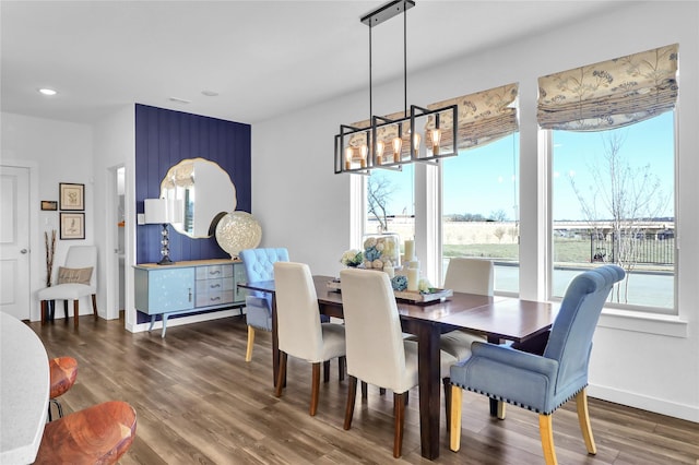 dining room featuring dark hardwood / wood-style floors and a chandelier