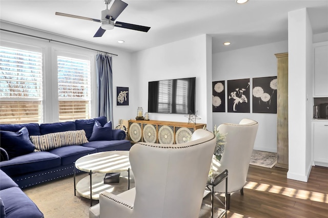 living room featuring wood-type flooring and ceiling fan