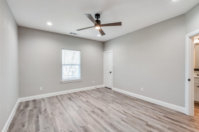 empty room featuring ceiling fan and light wood-type flooring