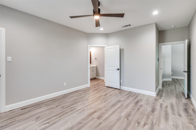 unfurnished bedroom featuring ceiling fan, light hardwood / wood-style floors, and ensuite bath