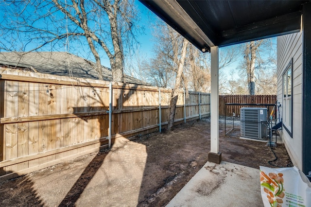 view of yard with a patio and central air condition unit