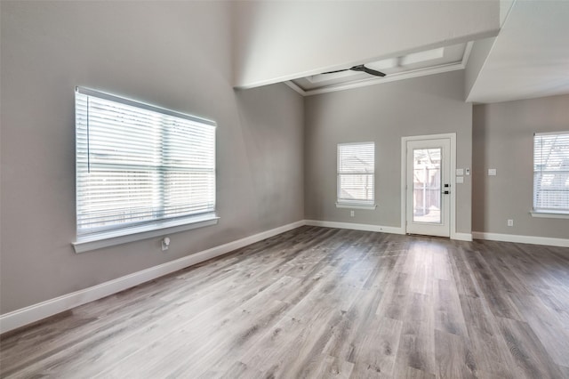 interior space with ornamental molding and light wood-type flooring