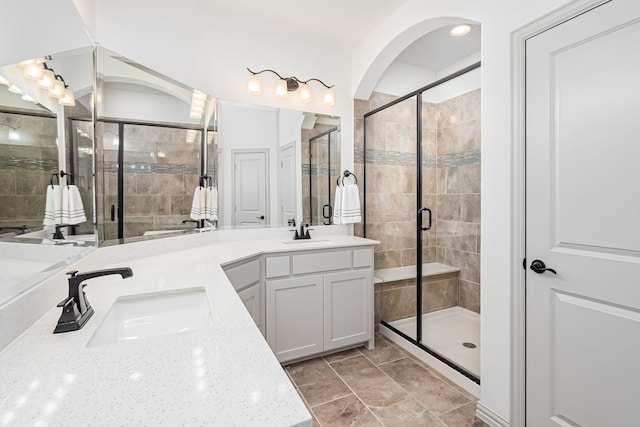 bathroom with vanity and a shower with door