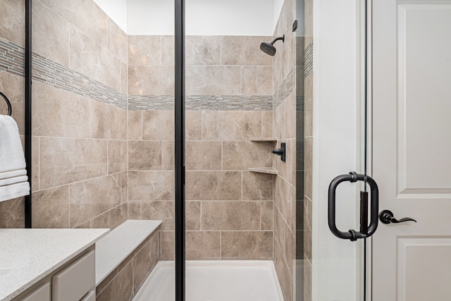 bathroom with vanity and a shower with shower door