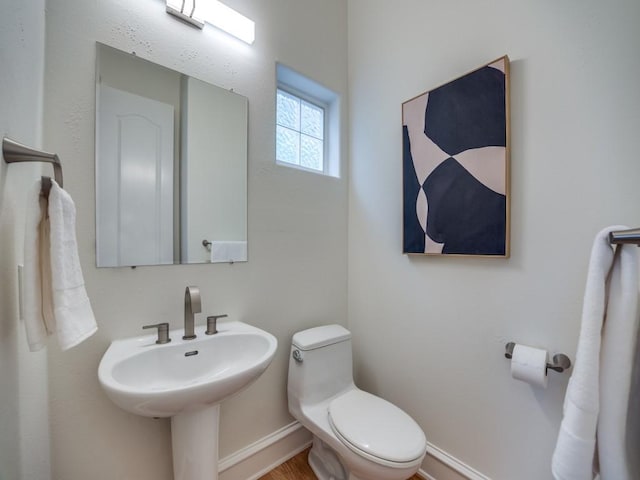 bathroom featuring toilet and sink