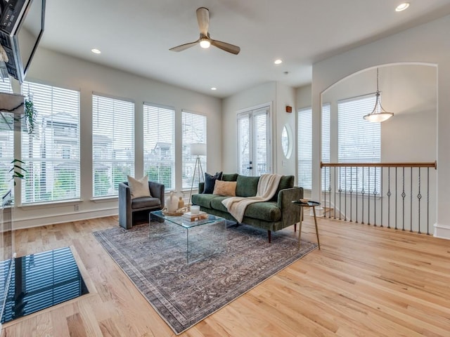 living room featuring ceiling fan and light hardwood / wood-style floors