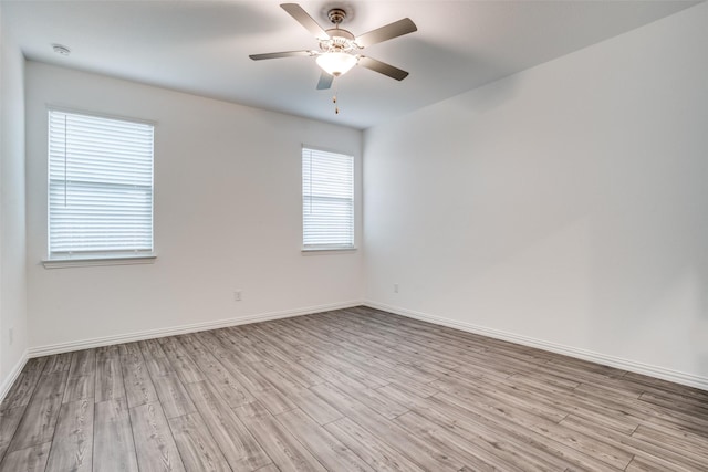 unfurnished room with ceiling fan and light wood-type flooring