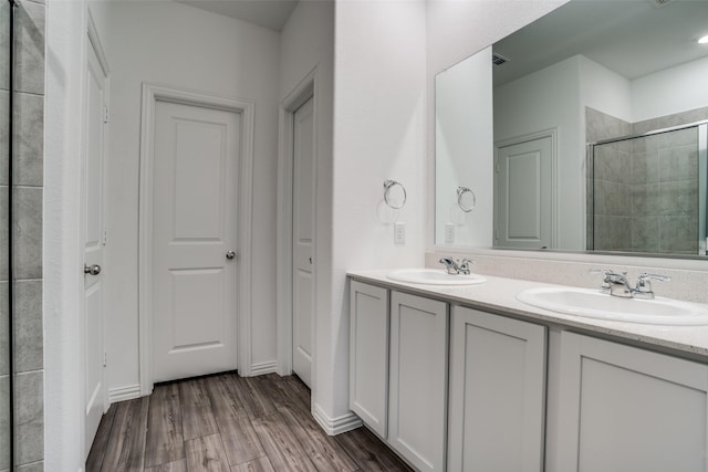 bathroom with vanity, hardwood / wood-style floors, and a shower with shower door